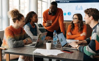 Professionals collaborating over AI tools in a modern business environment, emphasizing innovation and efficiency